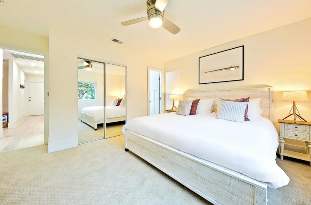 436 Alviso Way Encinitas, CA 92024 - Photo 15 of 18 a spacious bedroom with a bed and a chandelier