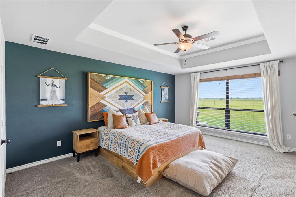 2990 Wilson Road Palmer, TX 75152 - Photo 29 of 40 a bedroom with a bed a chandelier and a large window