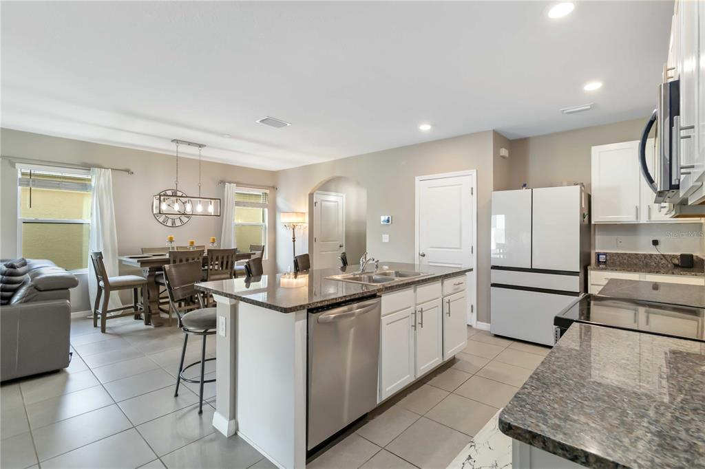 5904 Silver Sage Way Sarasota, FL 34232 - Photo 11 of 43 a kitchen with stainless steel appliances granite countertop a sink and cabinets