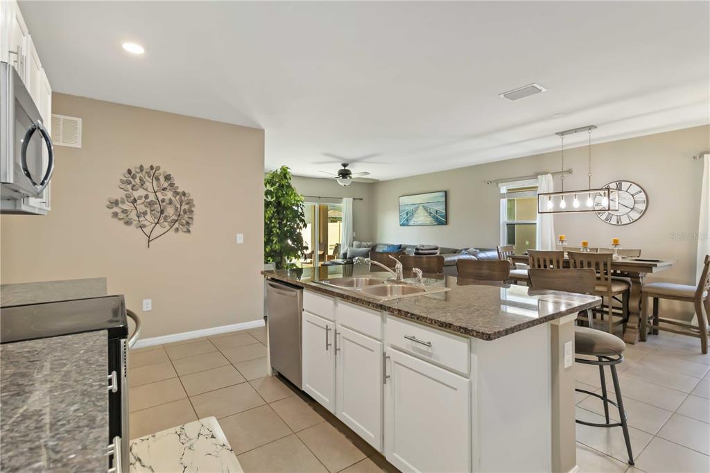 5904 Silver Sage Way Sarasota, FL 34232 - Photo 12 of 43 a kitchen with sink cabinets and dining table