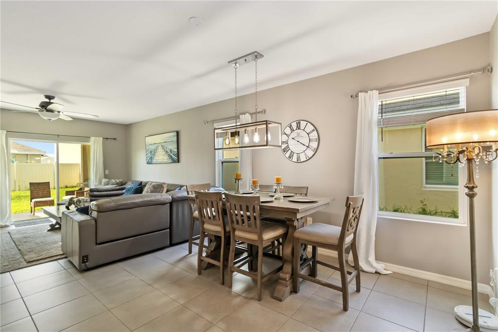 5904 Silver Sage Way Sarasota, FL 34232 - Photo 13 of 43 a view of a dining room and livingroom with furniture a flat screen tv and a window
