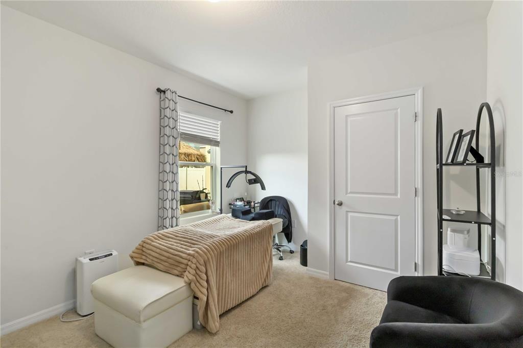 5904 Silver Sage Way Sarasota, FL 34232 - Photo 18 of 43 a bedroom with bed and a couch