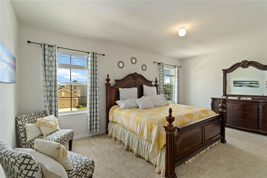 5904 Silver Sage Way Sarasota, FL 34232 - Photo 23 of 43 a bedroom with a bed and dresser