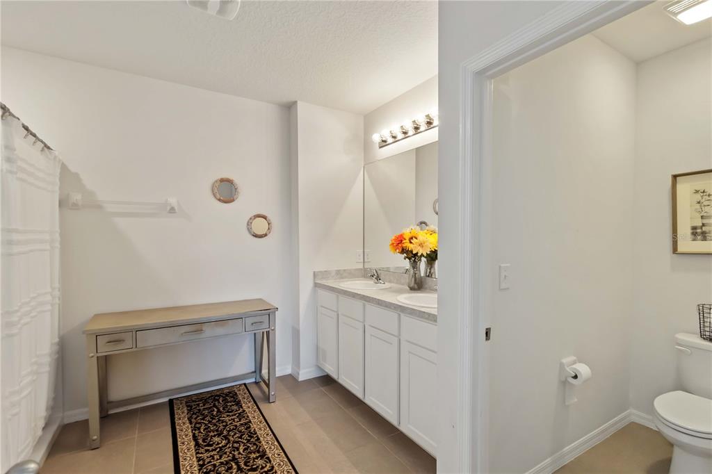 5904 Silver Sage Way Sarasota, FL 34232 - Photo 26 of 43 a bathroom with a sink toilet and shower