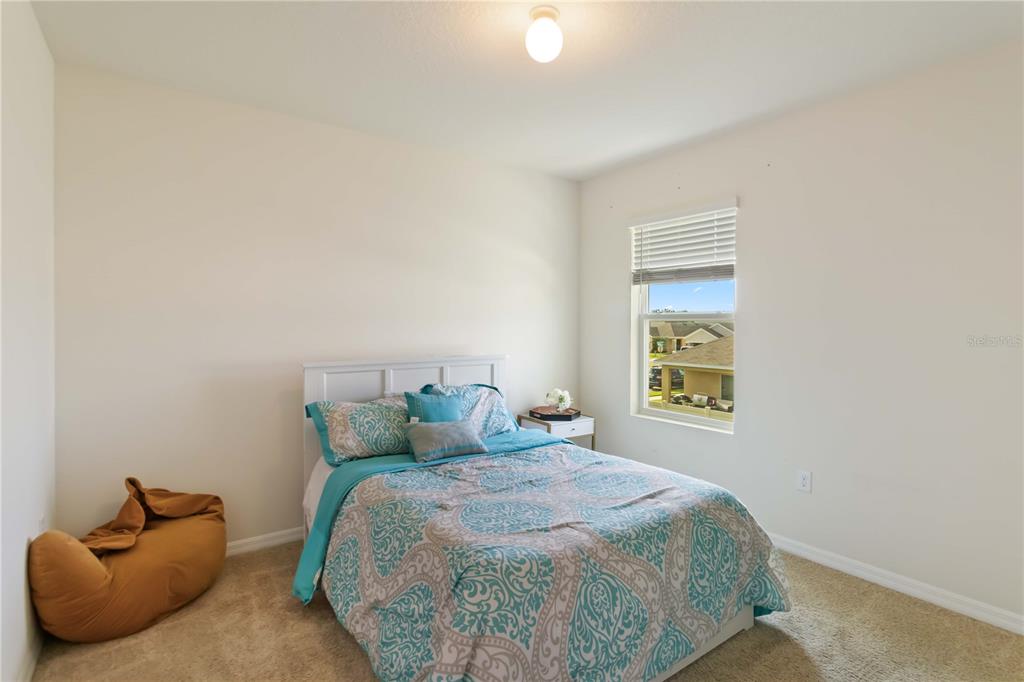 5904 Silver Sage Way Sarasota, FL 34232 - Photo 28 of 43 a bedroom with a bed and window