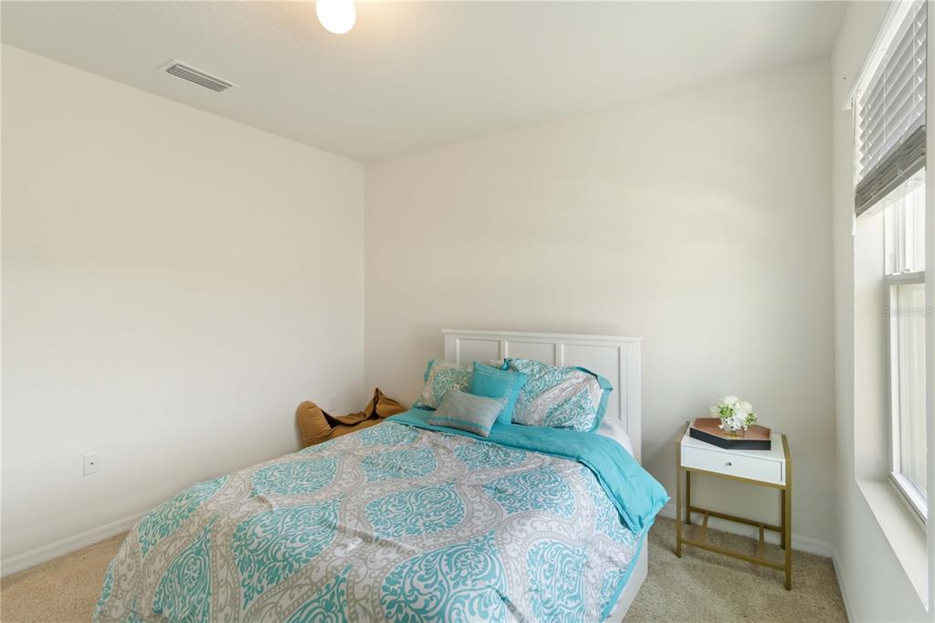 5904 Silver Sage Way Sarasota, FL 34232 - Photo 29 of 43 a bedroom with a bed and a window