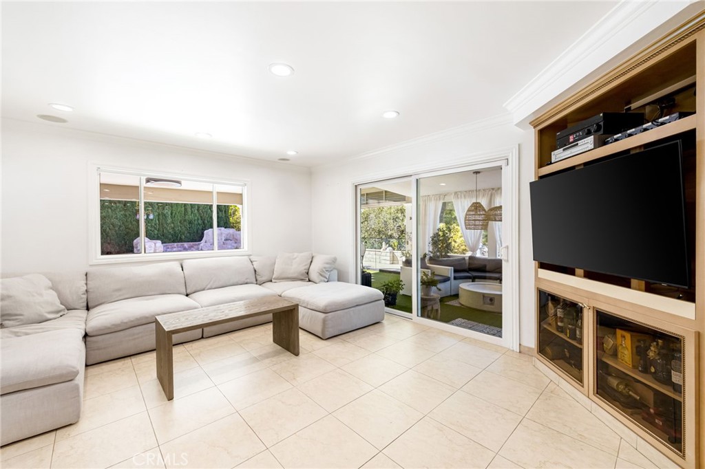 12115 Braemore Place Porter Ranch, CA 91326 - Photo 12 of 36 a living room with furniture and a flat screen tv