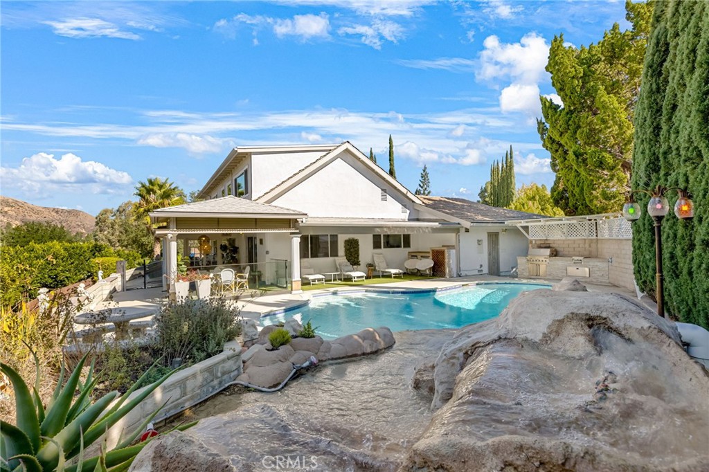 12115 Braemore Place Porter Ranch, CA 91326 - Photo 16 of 36 a front view of a house with garden