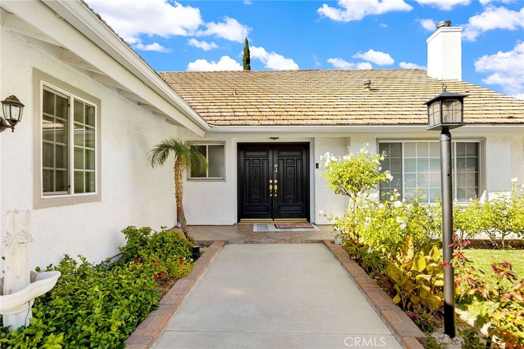 12115 Braemore Place Porter Ranch, CA 91326 - Photo 2 of 36 a view of a house with potted plants