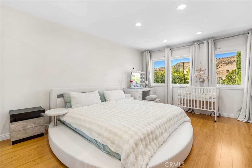 12115 Braemore Place Porter Ranch, CA 91326 - Photo 21 of 36 a bedroom with a bed and a large window