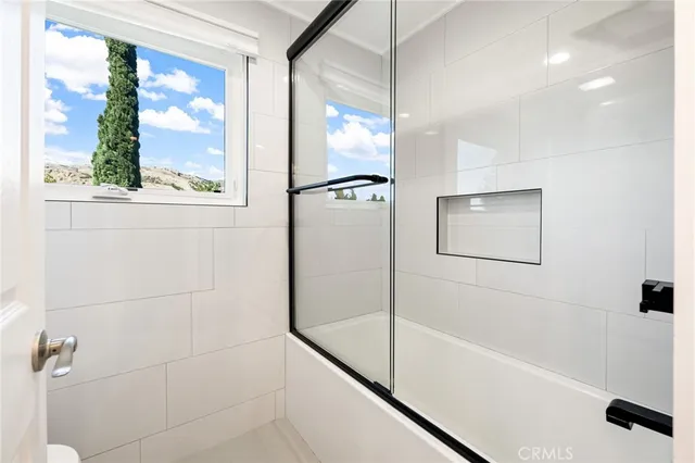 a bathroom with a bathtub and a shower