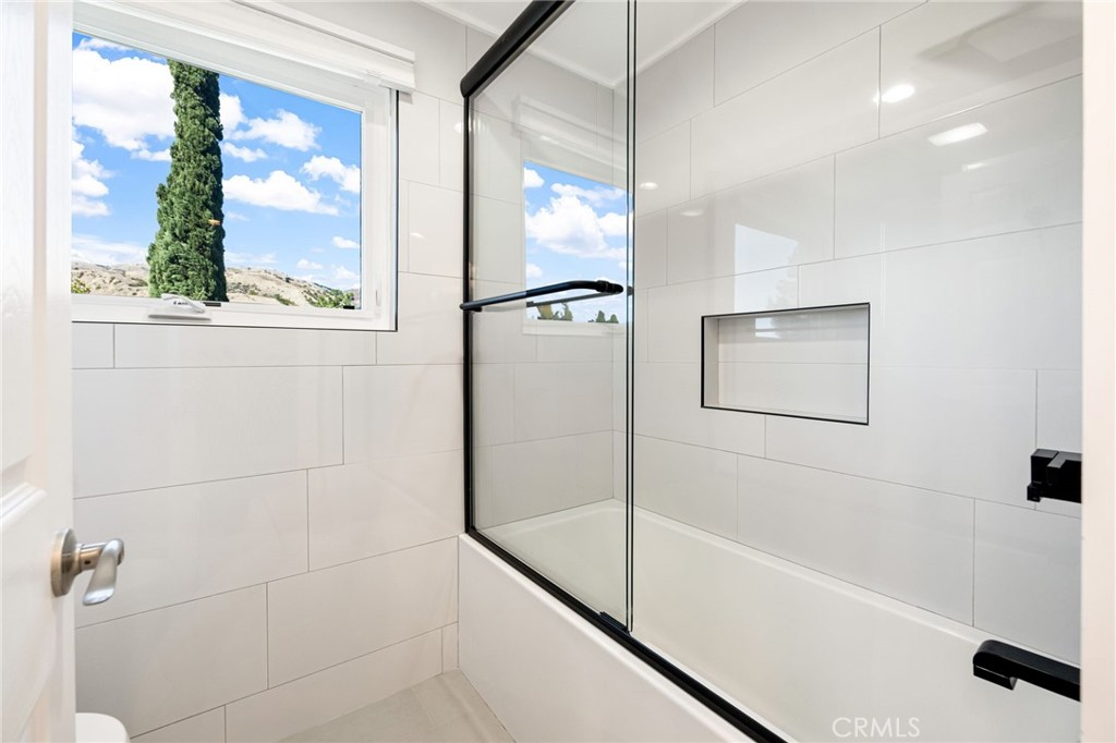 12115 Braemore Place Porter Ranch, CA 91326 - Photo 26 of 36 a bathroom with a bathtub and a shower