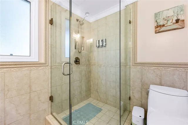 a bathroom with a shower and toilet