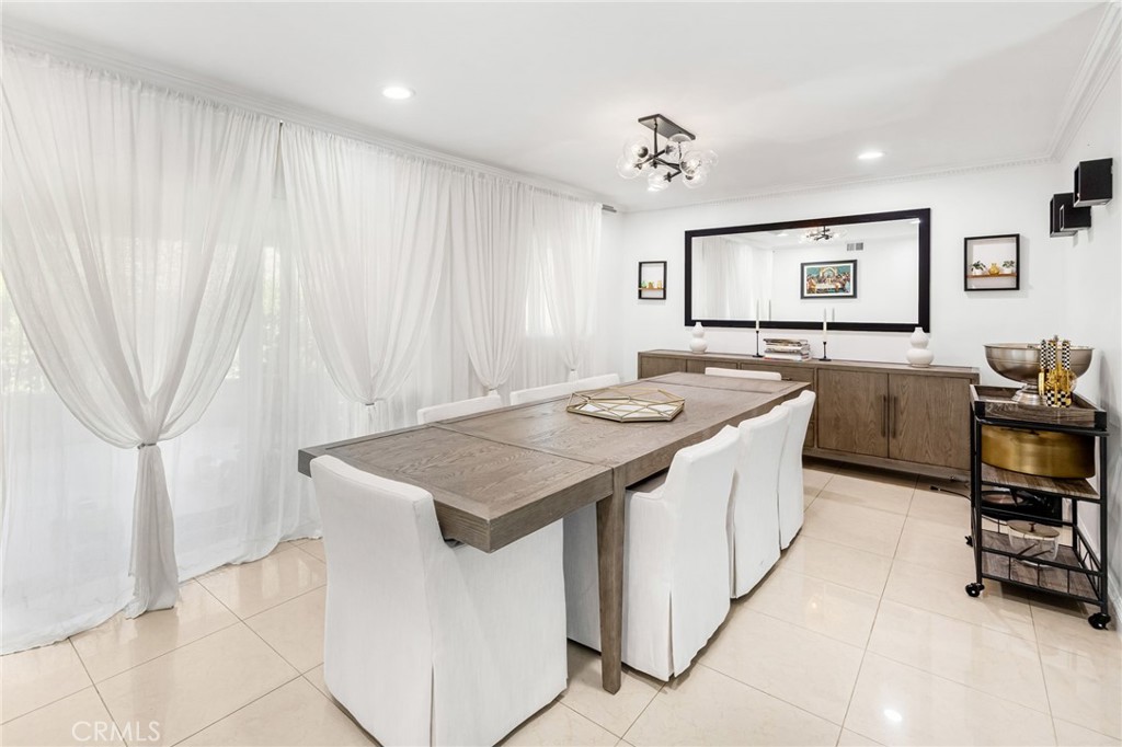 12115 Braemore Place Porter Ranch, CA 91326 - Photo 6 of 36 a kitchen that has a sink a table and chairs in it