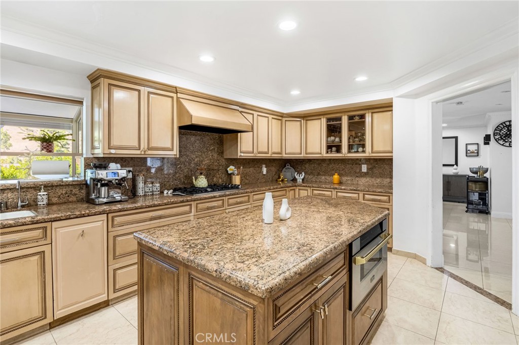 12115 Braemore Place Porter Ranch, CA 91326 - Photo 8 of 36 a kitchen with stainless steel appliances granite countertop a sink and a counter space