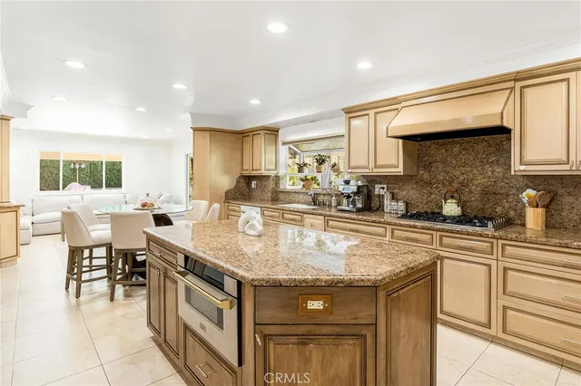 a kitchen with stainless steel appliances granite countertop a sink and cabinets