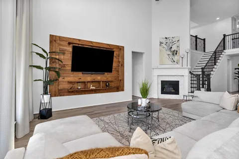 a living room with furniture a fireplace and a flat screen tv