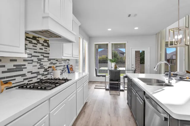 a kitchen with stainless steel appliances kitchen island granite countertop a sink stove and cabinets