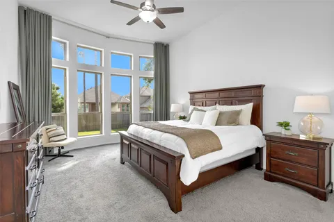 a large bed sitting in a room next to a window