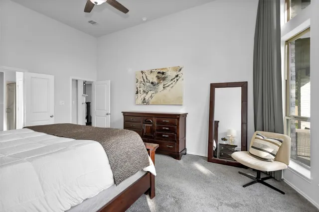 a spacious bedroom with a bed and a fireplace