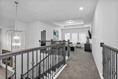 a view of a hallway with living room and dining room