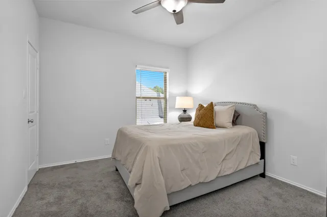 a bedroom with a bed and window