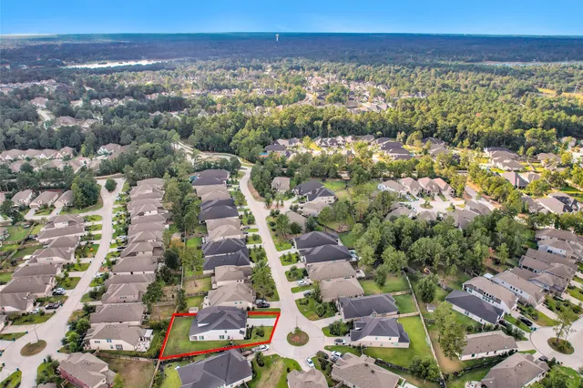 an aerial view of a house with a garden and swimming pool