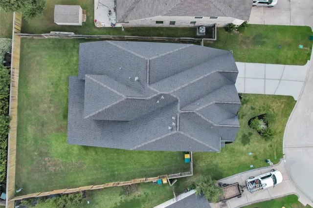 a front view of a house with a yard and potted plants