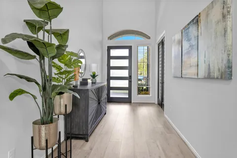 a view of living room with furniture and a potted plant