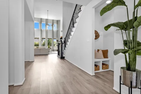 a view of entryway with wooden floor and stairs