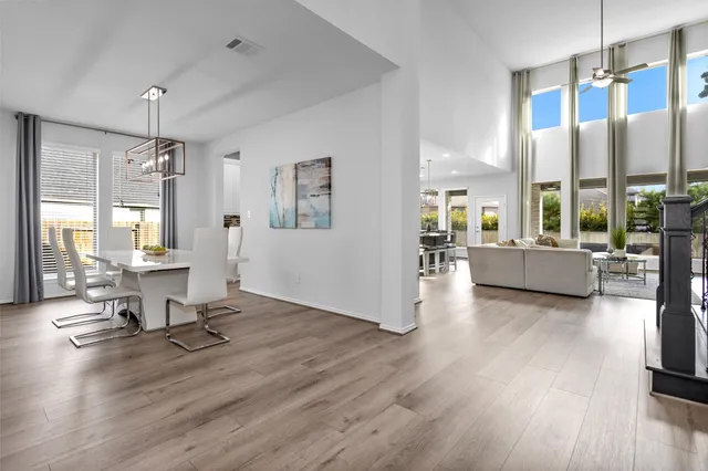 a living room with furniture wooden floor and a large window