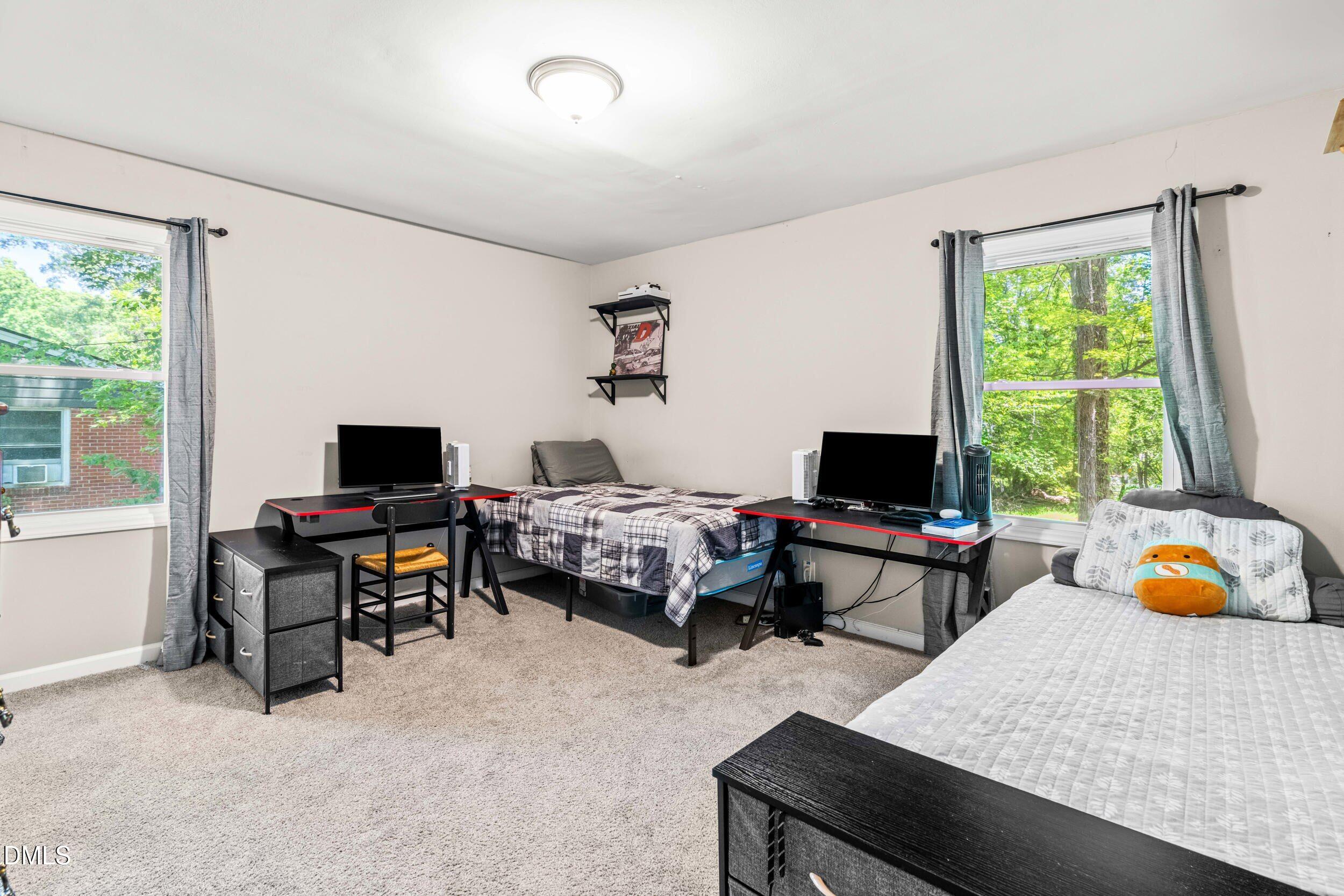 3724 Randell Road Garner, NC 27529 - Photo 22 of 32 a bedroom with a bed and a computer on the desk next to a window