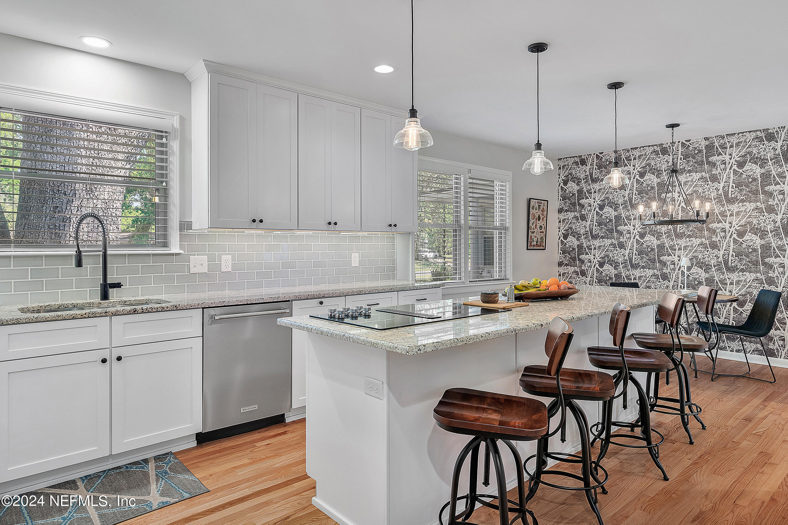 4724 Devon Lane Jacksonville, FL 32210 - Photo 11 of 40 a kitchen with stainless steel appliances kitchen island a table chairs sink and cabinets
