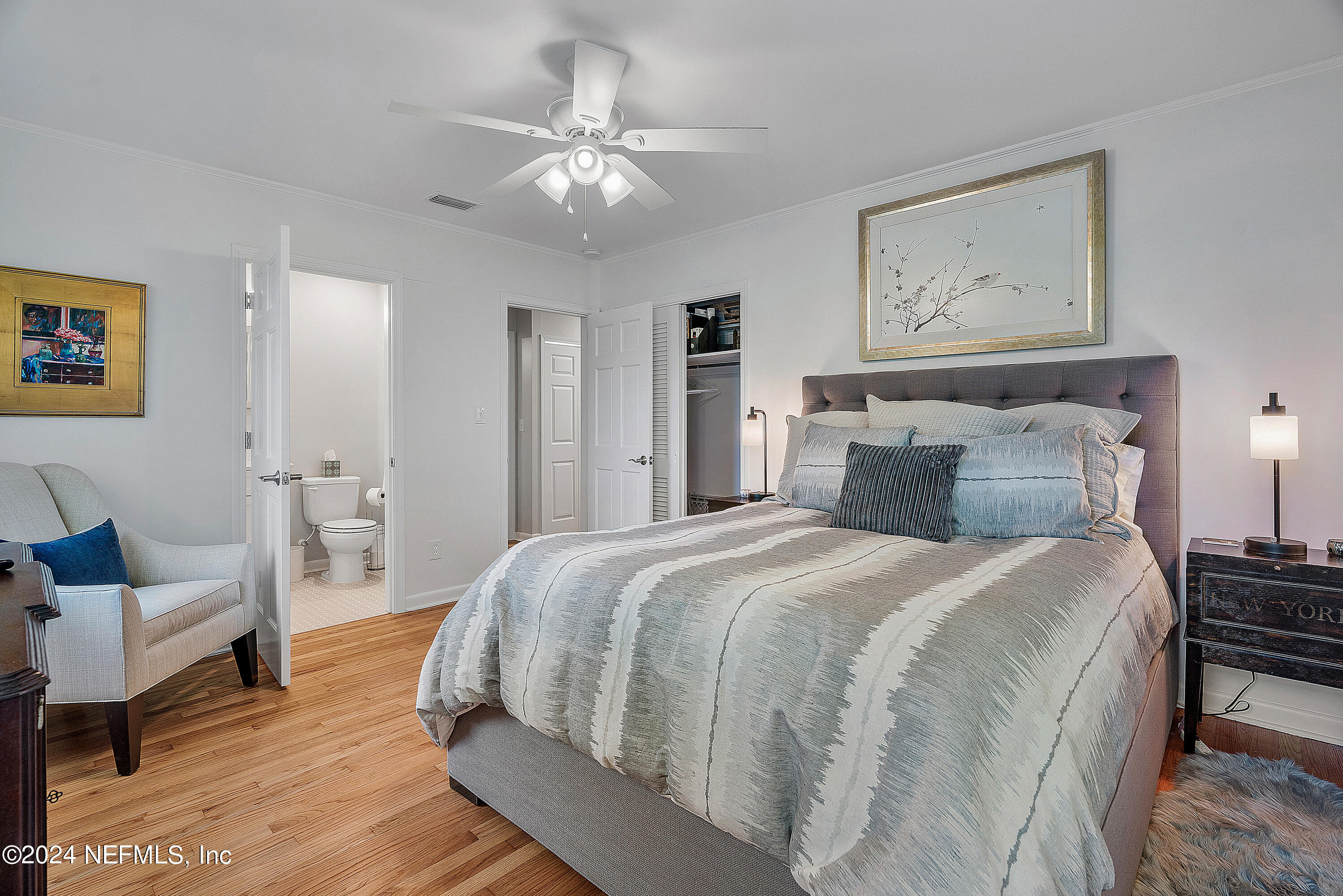 4724 Devon Lane Jacksonville, FL 32210 - Photo 25 of 40 a spacious bedroom with a bed and a chandelier