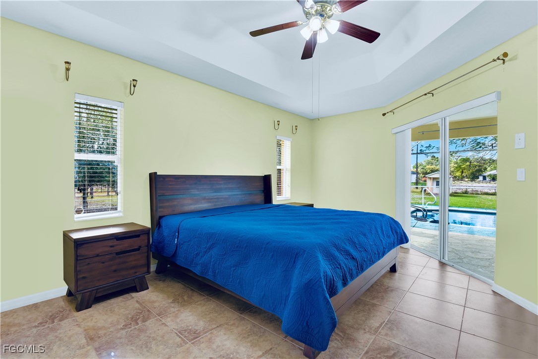 909 Magnolia Avenue Lehigh Acres, FL 33972 - Photo 11 of 38 a bedroom with a bed and a window