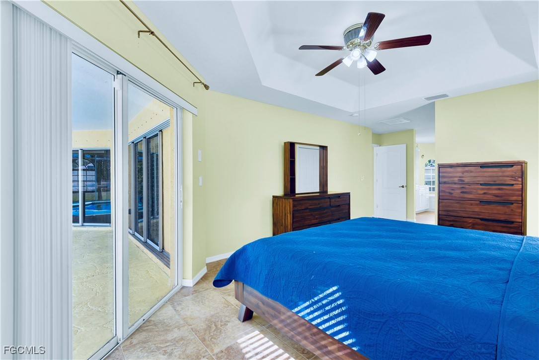 909 Magnolia Avenue Lehigh Acres, FL 33972 - Photo 15 of 38 a bedroom with a bed and a dresser