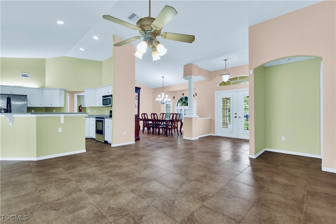 909 Magnolia Avenue Lehigh Acres, FL 33972 - Photo 18 of 38 a view of a kitchen with furniture and a kitchen