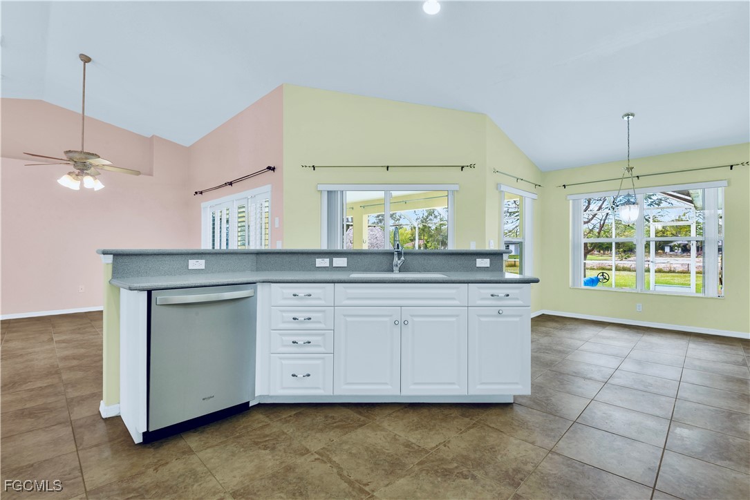 909 Magnolia Avenue Lehigh Acres, FL 33972 - Photo 21 of 38 a spacious bathroom with a granite countertop sink a mirror and a vanity