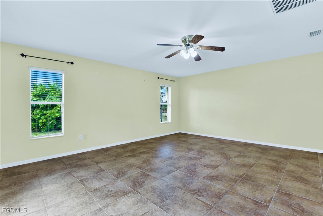 909 Magnolia Avenue Lehigh Acres, FL 33972 - Photo 24 of 38 a view of an empty room with a window