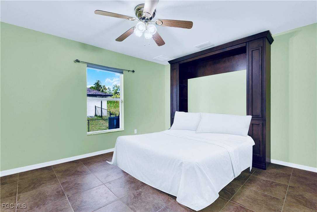 909 Magnolia Avenue Lehigh Acres, FL 33972 - Photo 26 of 38 a bedroom with a bed and a window