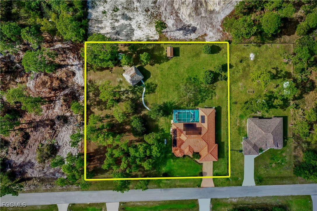 909 Magnolia Avenue Lehigh Acres, FL 33972 - Photo 3 of 38 an aerial view of a garden