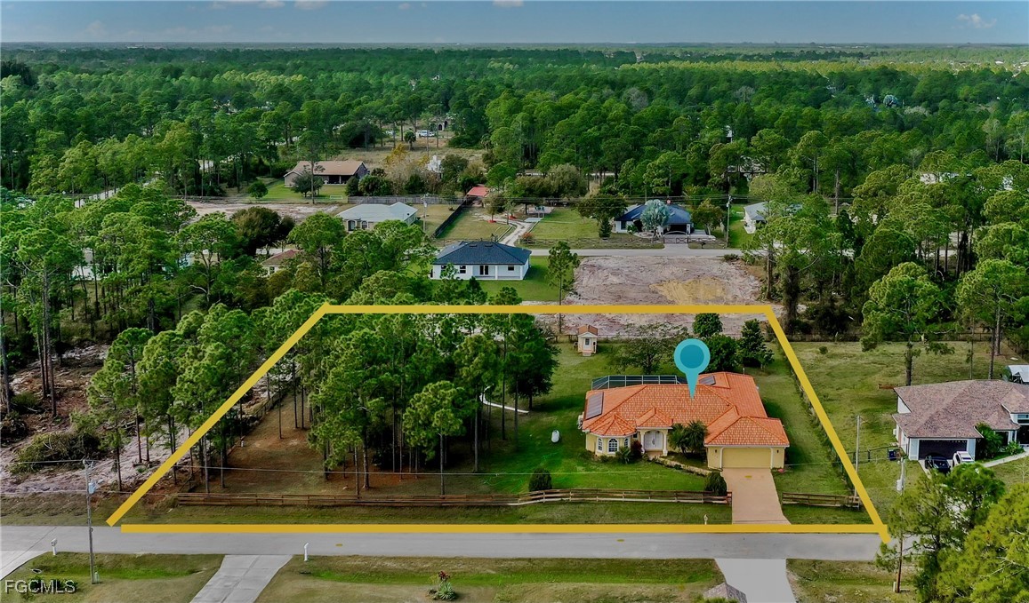 909 Magnolia Avenue Lehigh Acres, FL 33972 - Photo 37 of 38 a view of a garden with cars parked