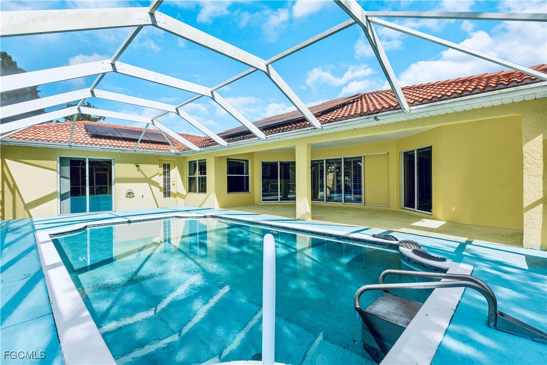 909 Magnolia Avenue Lehigh Acres, FL 33972 - Photo 4 of 38 a view of a house with a swimming pool