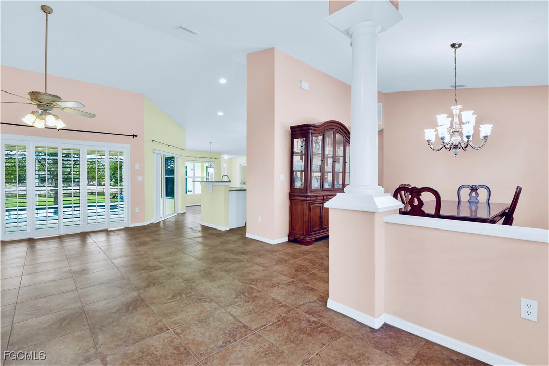 909 Magnolia Avenue Lehigh Acres, FL 33972 - Photo 8 of 38 a view of a room with a chandelier