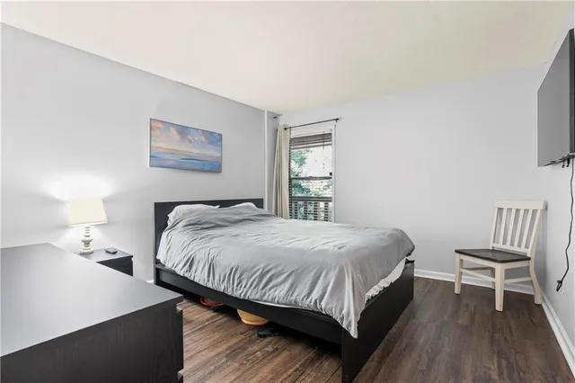 a bedroom with a bed and a chair