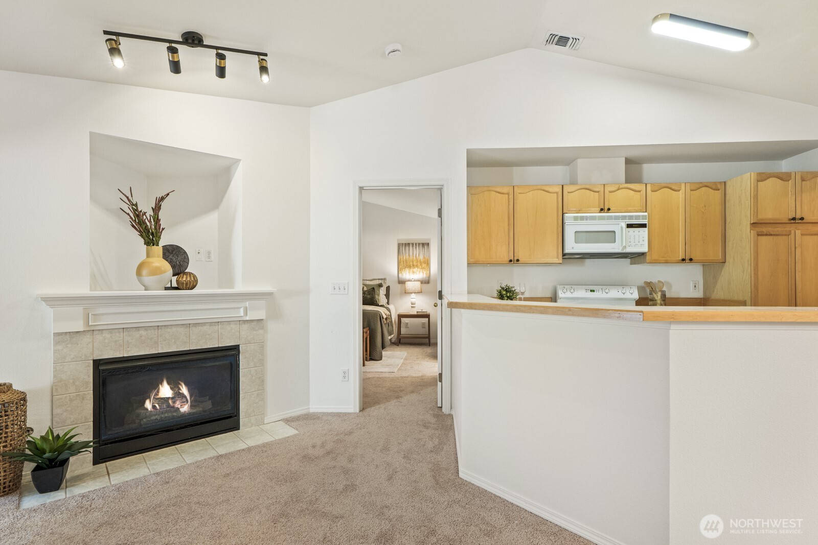 17204 123rd Place Northeast, Unit N304 Bothell, WA 98011 - Photo 20 of 40 a living room with stainless steel appliances furniture a fireplace and a open kitchen view
