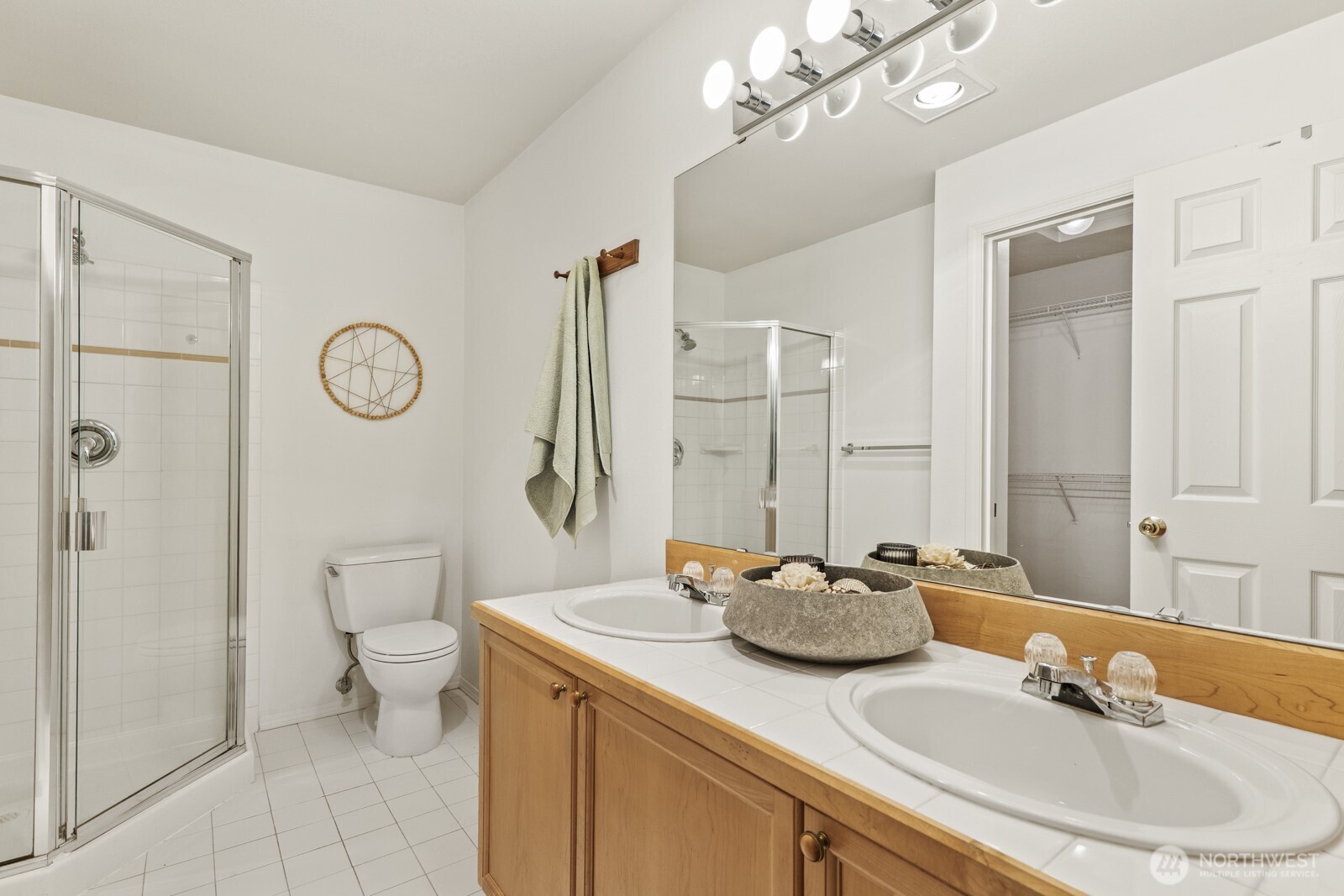 17204 123rd Place Northeast, Unit N304 Bothell, WA 98011 - Photo 24 of 40 a bathroom with a double vanity sink mirror and toilet