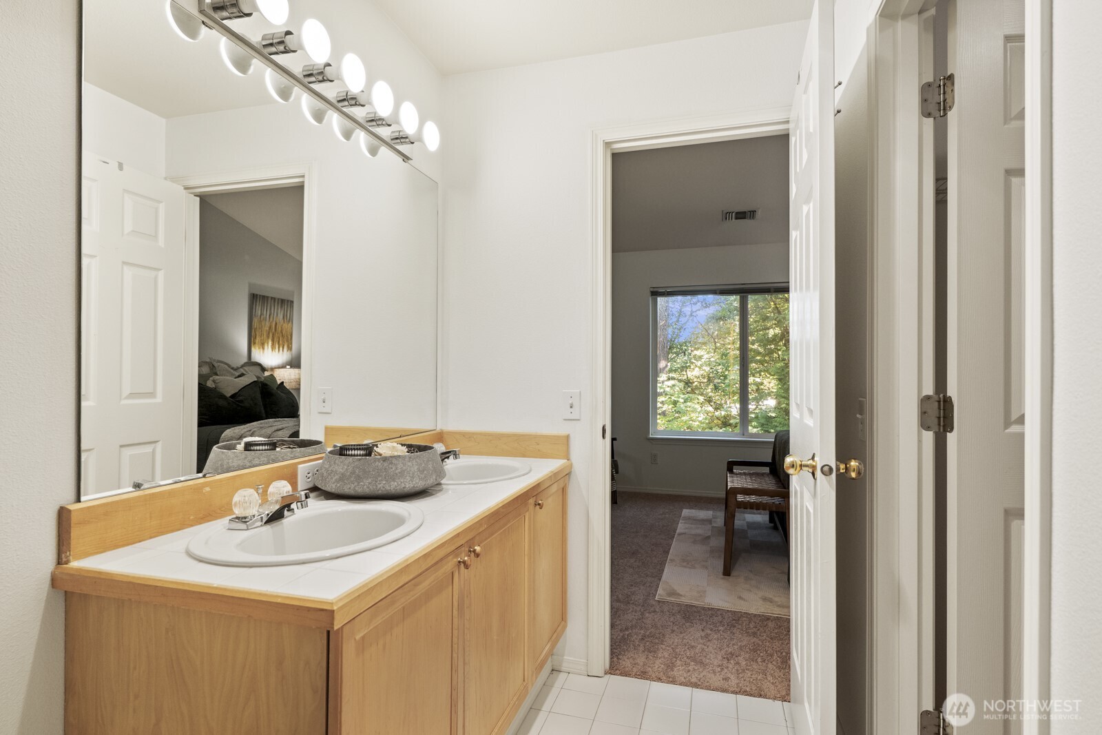 17204 123rd Place Northeast, Unit N304 Bothell, WA 98011 - Photo 25 of 40 a bathroom with a sink a toilet and a mirror