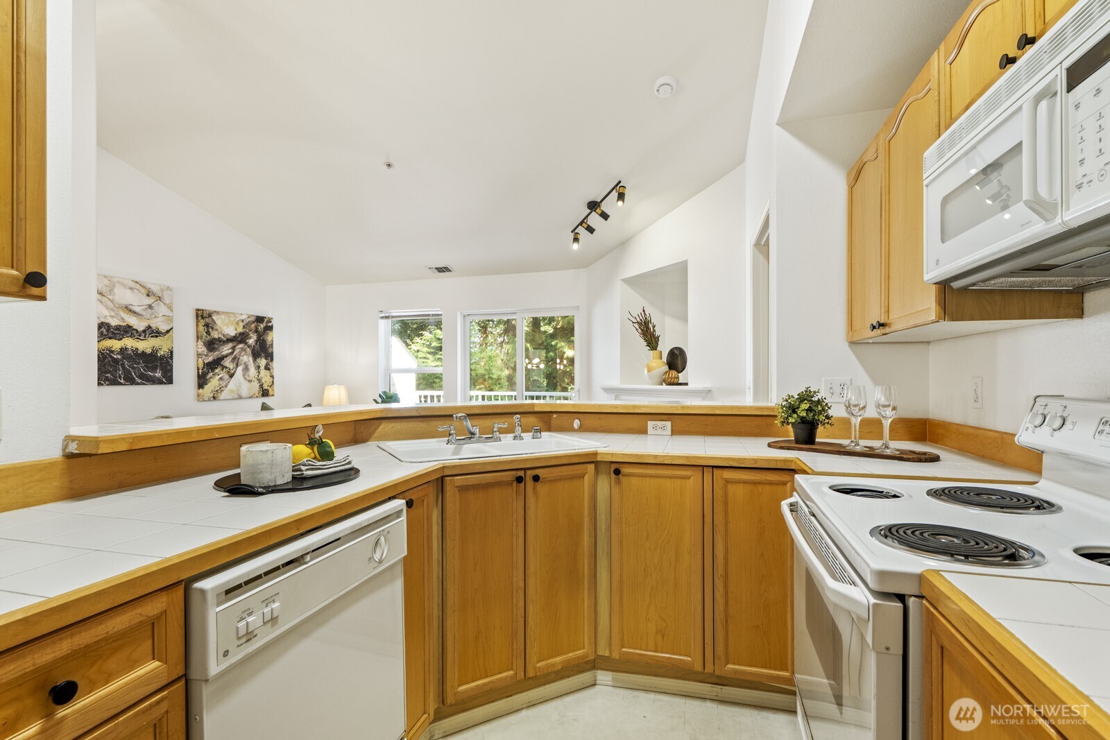 17204 123rd Place Northeast, Unit N304 Bothell, WA 98011 - Photo 28 of 40 a kitchen with a sink stove and cabinets