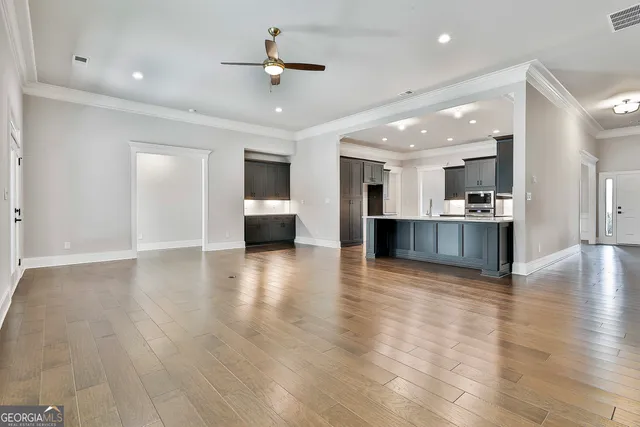 a view of a living room a kitchen and a stove